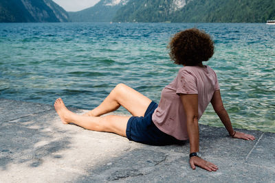 Side view of mature woman relaxing by lake