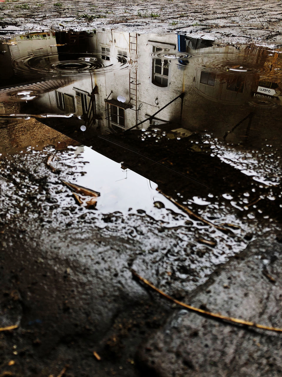 HIGH ANGLE VIEW OF PUDDLE ON RIVER BY OLD BUILDINGS