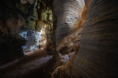 Full length of woman standing in cave