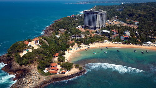 High angle view of buildings by sea