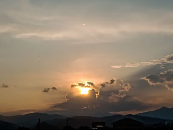 Scenic view of silhouette mountains against sky during sunset