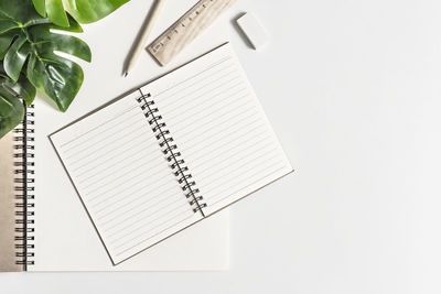 High angle view of pen and paper against white background