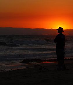 Silhouette of people looking at sunset