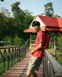 Full length of senior woman standing on footbridge