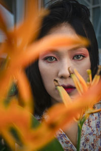 Portrait of young woman holding camera