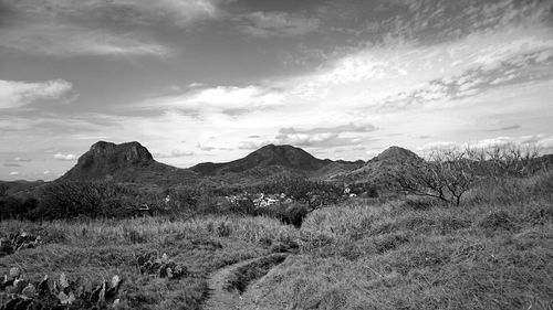 Scenic view of mountains against cloudy sky