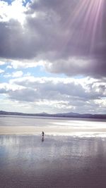 Scenic view of sea against cloudy sky
