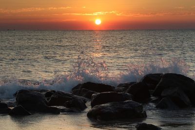 Scenic view of sea against romantic sky at sunset