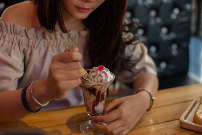 Midsection of woman holding ice cream