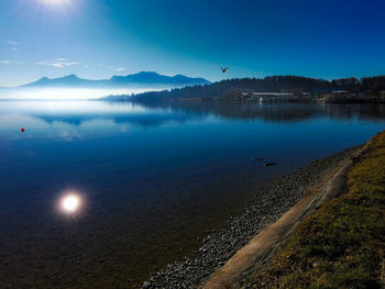 Scenic view of lake against blue sky