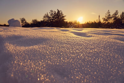 Scenic view of snow field against sky during sunset