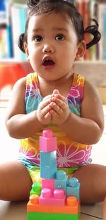 Cute baby girl playing with toy blocks