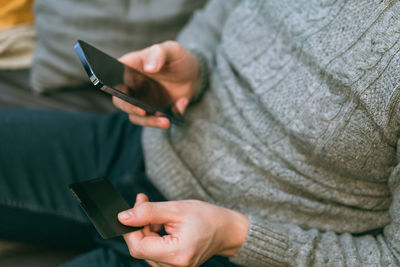 Midsection of woman using mobile phone