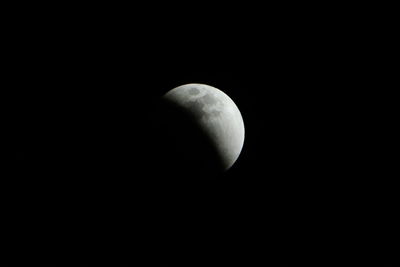 Low angle view of half moon against sky at night
