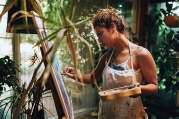 Woman painting while standing at home