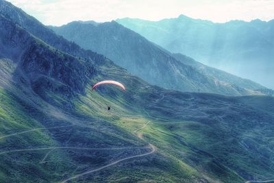 People hiking on grassy field