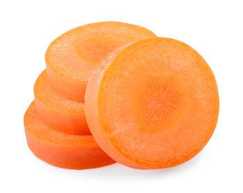 Close-up of orange slices over white background