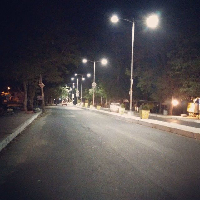 street light, night, illuminated, the way forward, lighting equipment, transportation, road, street, tree, diminishing perspective, empty road, empty, sky, vanishing point, road marking, outdoors, car, electric light, lamp post, asphalt