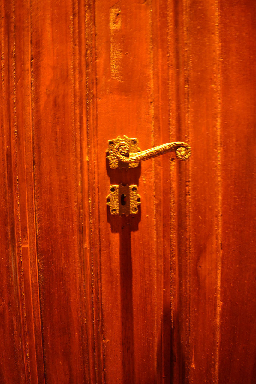 CLOSE-UP OF METAL DOOR WITH HANDLE ON BACKGROUND