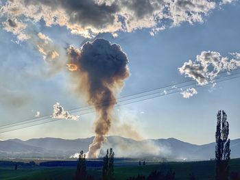 Low angle view of smoke emitting from chimney against sky