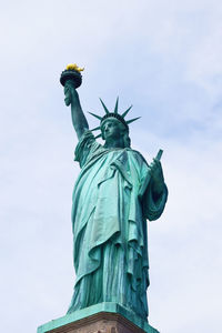 Low angle view of statue of liberty against sky