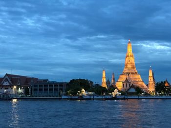 View of illuminated buildings against sky in city