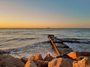 Scenic view of sea against clear sky during sunset