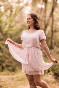 Happy woman standing on field