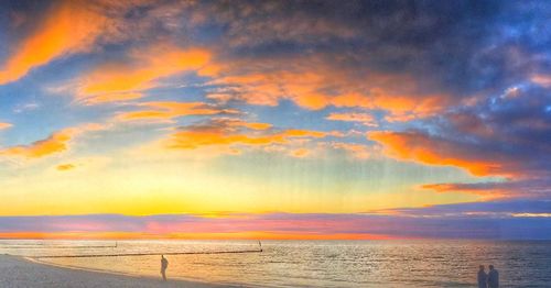 Scenic view of dramatic sky over sea during sunset