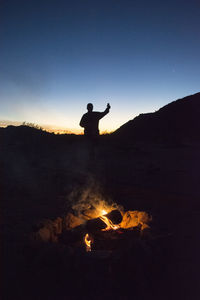 Silhouette man against mountain during sunset