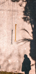 Shadow of people on wall looking at church bell rope