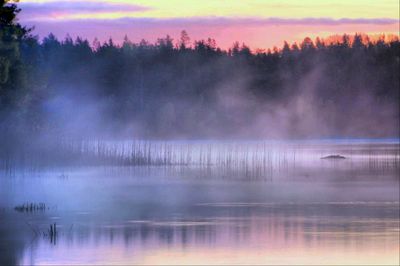 Scenic view of calm lake against sky