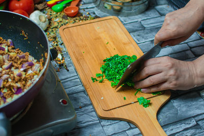 Cropped hands of man preparing food