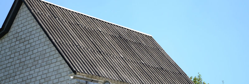 Low angle view of modern building against clear blue sky