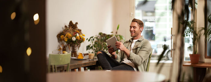 Young woman using mobile phone at home