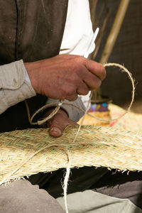 Craftsman's hands, working the esparto grass, handicrafts in the street