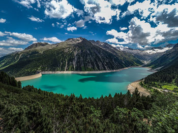 Scenic view of lake and mountains against sky