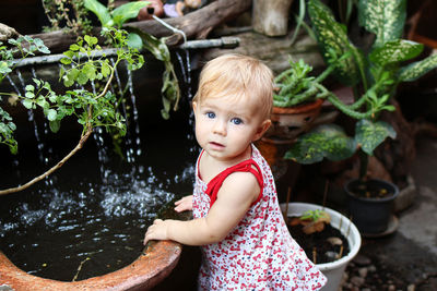 Portrait of cute girl standing in water
