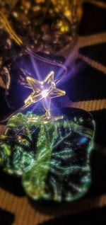 Close-up of illuminated christmas tree on table