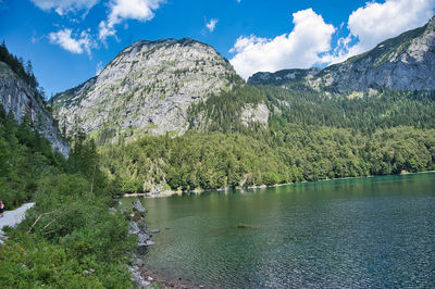 Scenic view of lake by mountains against sky