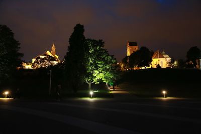View of illuminated street lights at night