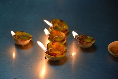 High angle view of illuminated candles on table