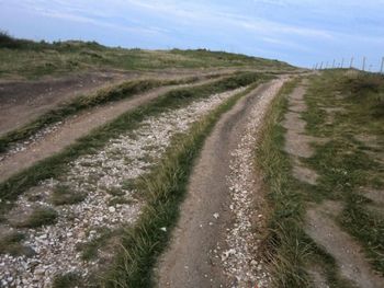 Empty road along countryside landscape