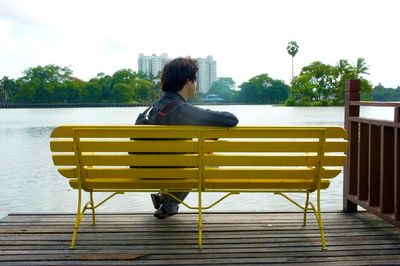 Full length of woman sitting on bench