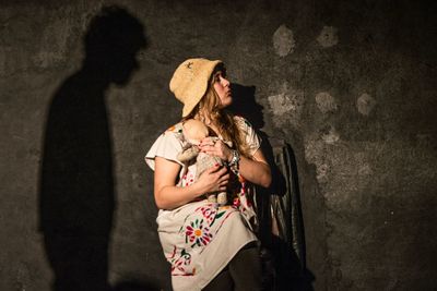 Rear view of couple standing against wall