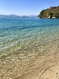 Scenic view of sea against clear blue sky