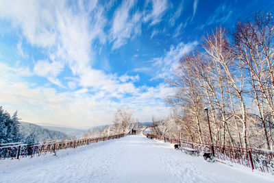 Snow covered landscape against sky