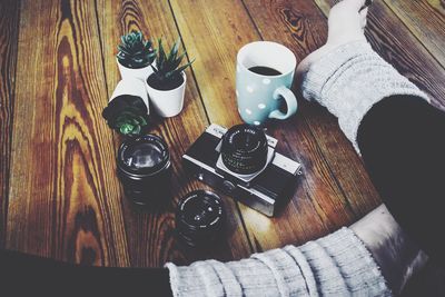 High angle view of man and coffee cup on table