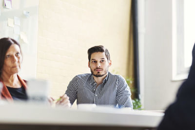 Businessman with female colleague in meeting room