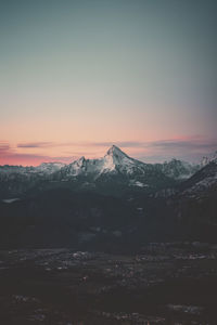 Scenic view of snowcapped mountains against sky during sunset